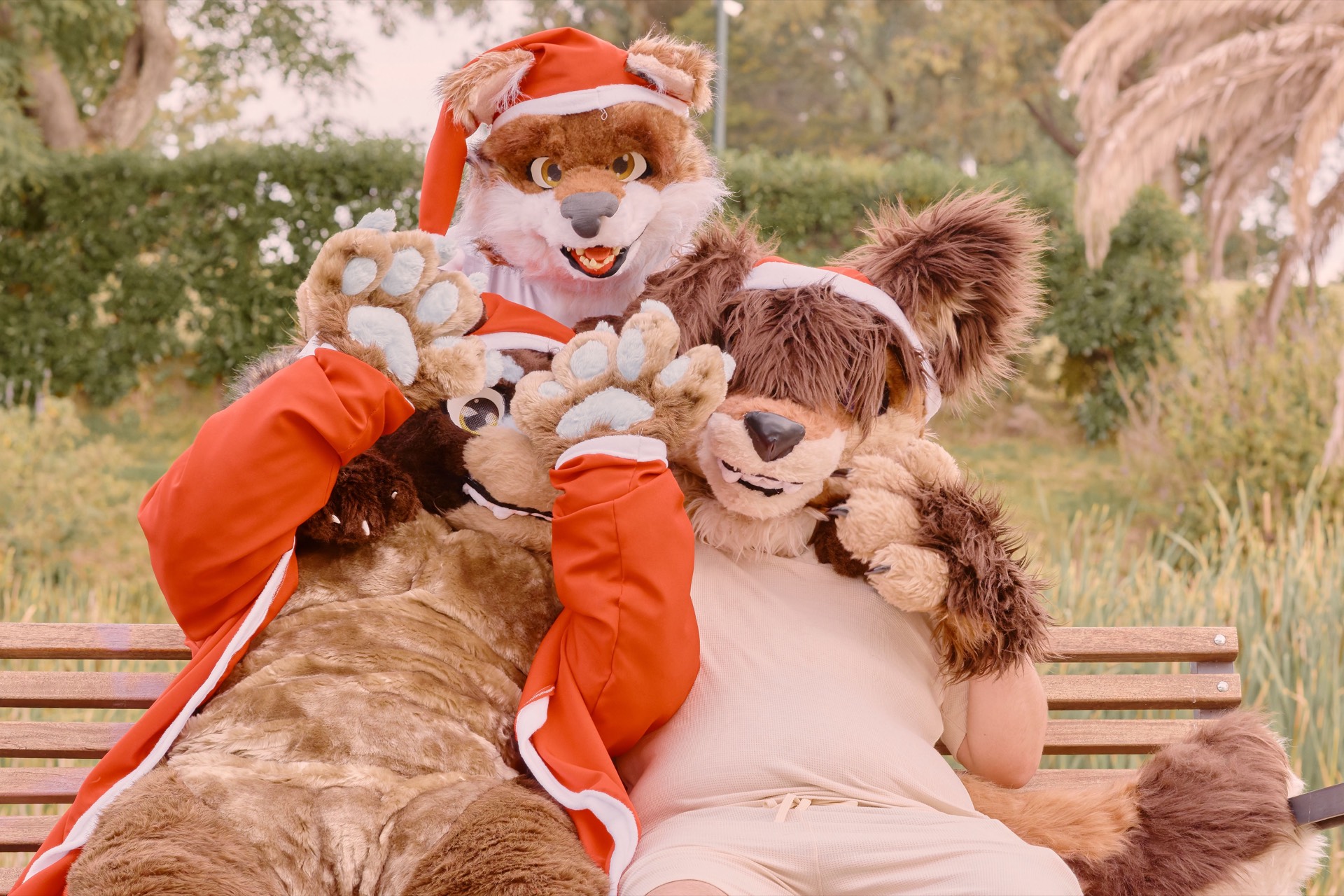 Illustrative photo of three fursuiters on a park bench